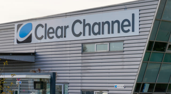 A photograph of a building with the logo for Clear Channel (CCO) on the side.