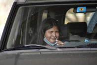 Ashley Ruiz gives herself a COVID-19 nasal swab test while sitting in a car at a drive-up CVS pharmacy in Dallas, Friday, Sept. 18, 2020. (AP Photo/LM Otero)