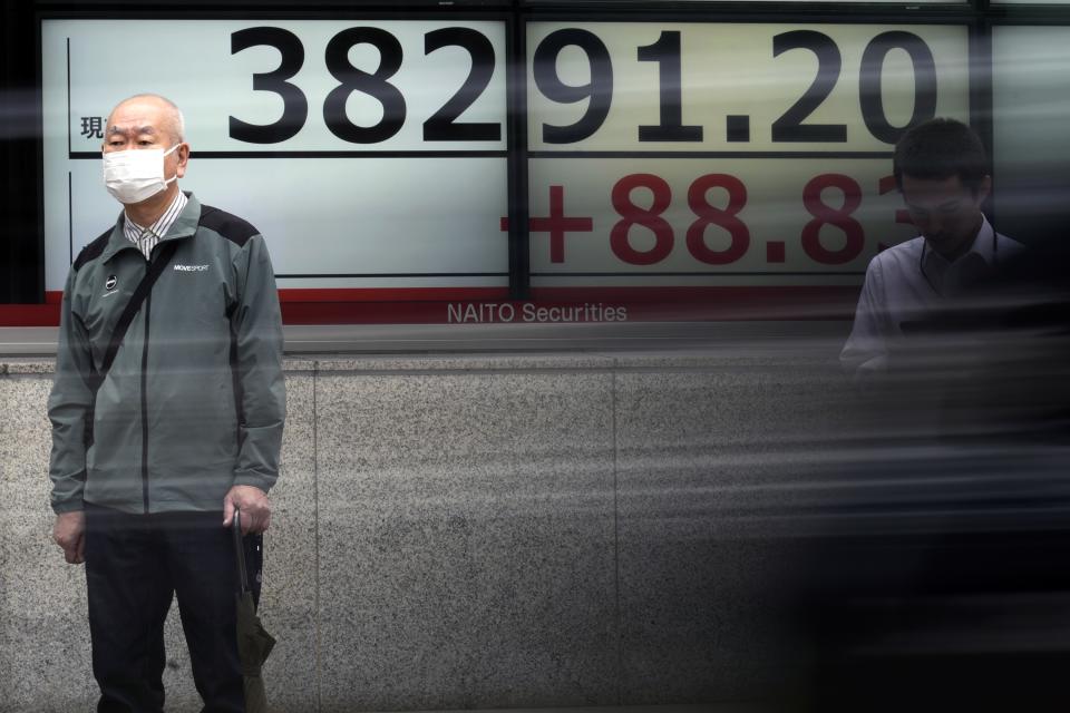 A person stands near an electronic stock board showing Japan's Nikkei 225 index at a securities firm Thursday, May 9, 2024, in Tokyo. (AP Photo/Eugene Hoshiko)