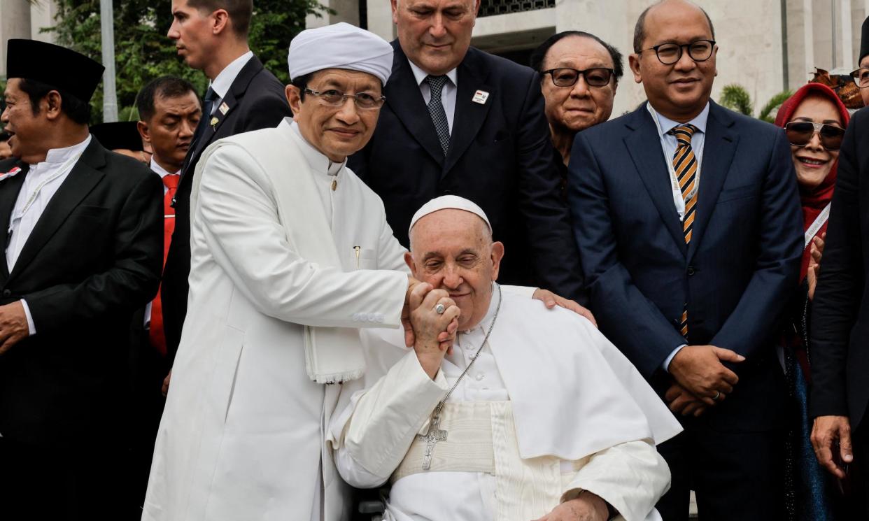 <span>Pope Francis (R) kisses the hand of the Grand Imam of Istiqlal Mosque Nasaruddin Umar during a meeting with other religious leaders at the Istiqlal Mosque in Jakarta.</span><span>Photograph: Yasuyoshi Chiba/AFP/Getty Images</span>