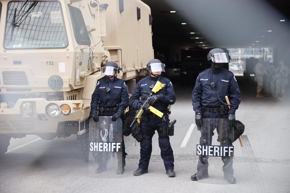 Police stand guard outside the Hennepin County Government Center as people await the verdict in the Derek Chauvin trial on April 20, 2021 In Minneapolis.