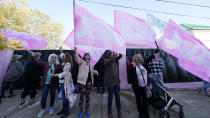 The Pink Flags wave their "Jesus" banners in opposition to abortion outside the Jackson Women's Health Organization, a state-licensed abortion clinic in Jackson, Miss., Wednesday, Dec. 1, 2021. A group of anti-abortion activists stood outside the clinic in an effort to dissuade patients from entering. On Wednesday, the U.S. Supreme Court heard a case that directly challenges the constitutional right to an abortion established nearly 50 years ago. (AP Photo/Rogelio V. Solis)