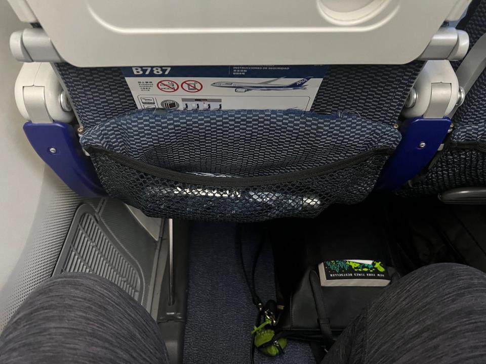My blue water bottle in the mesh pocket attached to the larger seatback pocket.