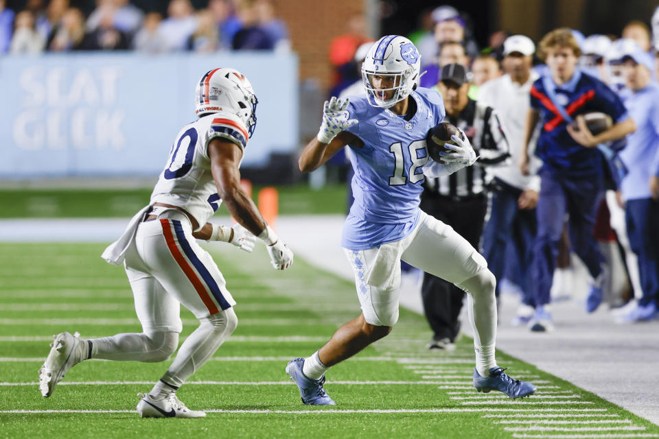 Oct 21, 2023; Chapel Hill, North Carolina, USA; North Carolina Tar Heels tight end <a class="link " href="https://sports.yahoo.com/ncaaf/players/324311" data-i13n="sec:content-canvas;subsec:anchor_text;elm:context_link" data-ylk="slk:Bryson Nesbit;sec:content-canvas;subsec:anchor_text;elm:context_link;itc:0">Bryson Nesbit</a> (18) runs after a catch as Virginia Cavaliers safety Jonas Sanker (20) forces him out of bounds in the second half at Kenan Memorial Stadium. Mandatory Credit: Nell Redmond-USA TODAY Sports