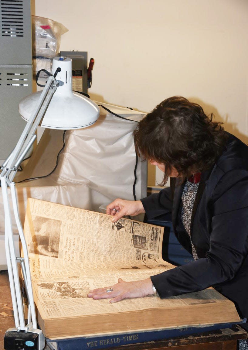 Herald-Times reporter Laura Lane searches for an article about the Argonaut Club in newspaper files at The Herald-Times.