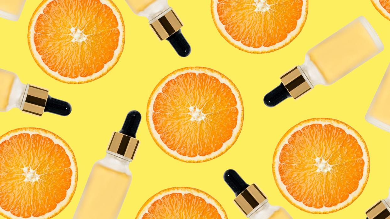 Beauty pattern made of Vitamin C serum in cosmetic bottle with dropper and slices of orange