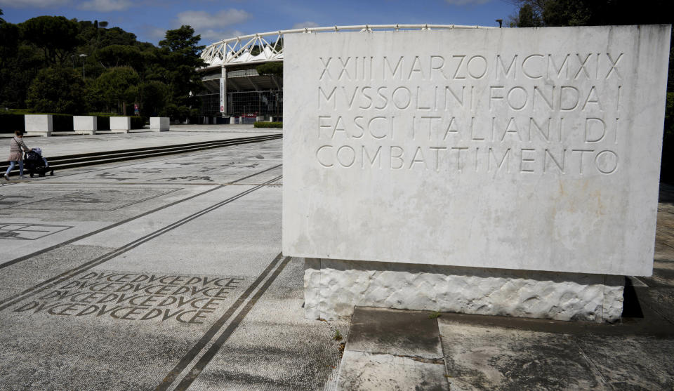 FILE - The word "duce", which was Benito Mussolini's title, is written on the mosaic pavement in front of the Olympic Stadium in Rome, Monday, May 6, 2019, next to a plaque commemorating the founding of Mussolini's Fasci Italiani di Combattimento (Italian Fighting Fasces) on March 23, 1919. Italy's failure to come to terms with its fascist past is more evident as it marks the 100th anniversary, Friday, Oct. 28, 2022, of the March on Rome that brought totalitarian dictator Benito Mussolini to power as the first postwar government led by a neo-fascist party takes office. (AP Photo/Andrew Medichini, File)