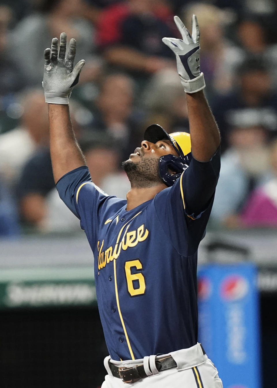Milwaukee Brewers' Lorenzo Cain celebrates a grand slam during the fifth inning of the team's baseball game against the Cleveland Indians, Friday, Sept. 10, 2021, in Cleveland. (AP Photo/Tony Dejak)