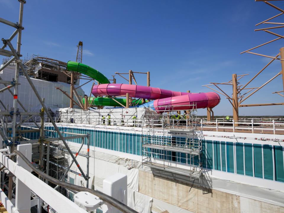 The Thrill Island neighborhood with water slides under scaffolding and tarps while it's being constructed on Royal Caribbean's Icon of the seas