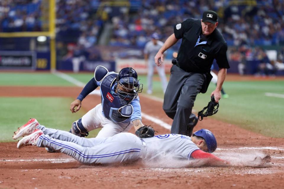 Sep 23, 2023; St. Petersburg, Florida, USA; Toronto Blue Jays left fielder Whit Merrifield (15) is tagged out at home plate by .Tampa Bay Rays catcher Christian Bethancourt (14) in the seventh inning at Tropicana Field.
