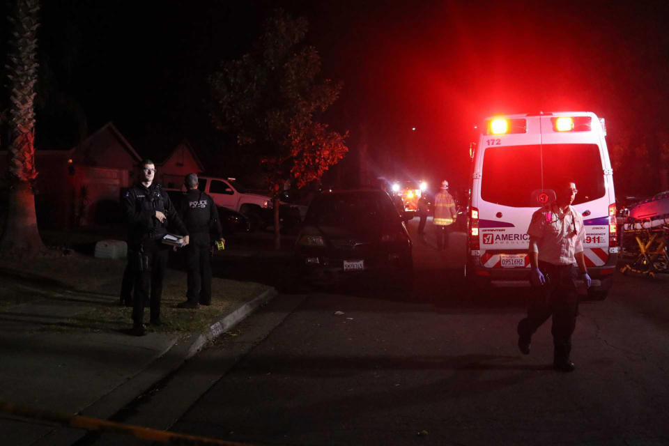 Police and emergency personnel work at the scene of a shooting at a backyard party, Sunday, Nov. 17, 2019, in southeast Fresno, Calif. (Photo: Larry Valenzuela/The Fresno Bee via AP)
