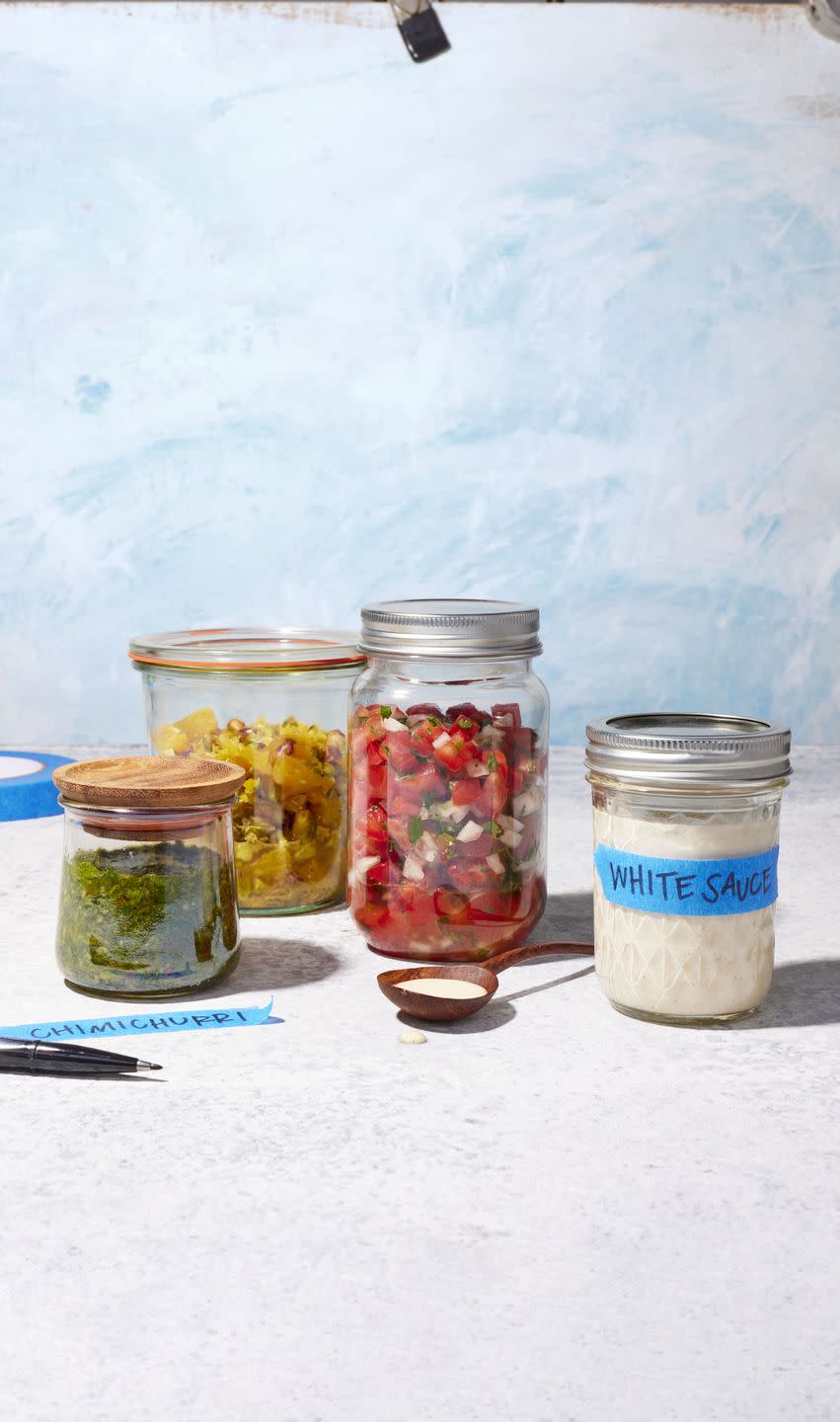 four mason jars of various homemade sauces for grilling