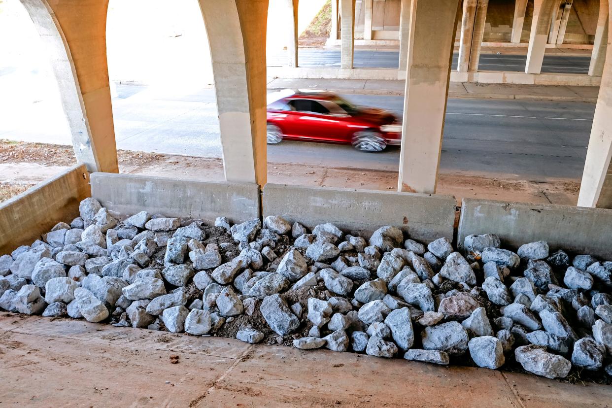 Concrete Jersey barriers and big rocks can be seen Dec. 18 at a recently cleared encampment site under the Interstate 44 bridge over N Pennsylvania Avenue.