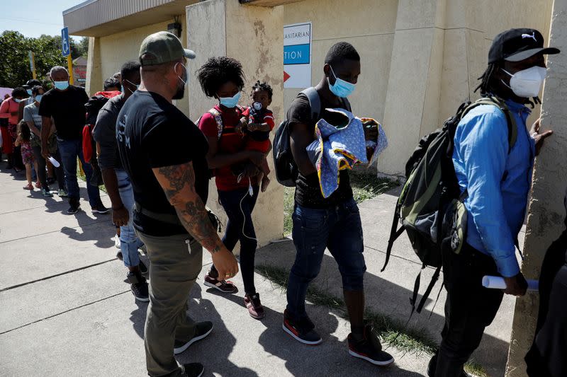 Migrants seeking asylum in the U.S. line up to board a bus to Houston from Val Verde Border Humanitarian Coalition after being released from U.S. Customs and Border Protection, in Del Rio