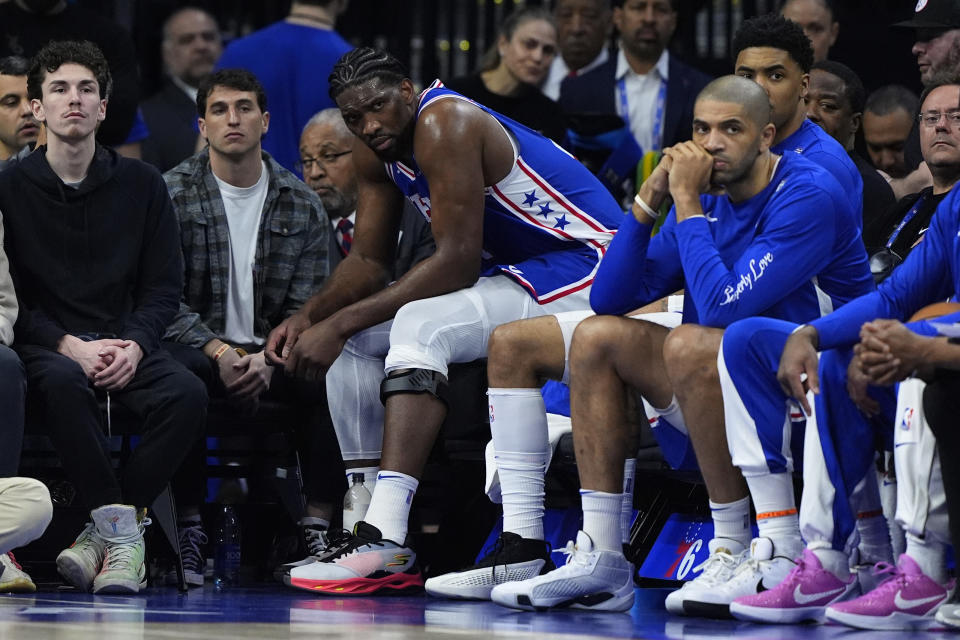 Philadelphia 76ers' Joel Embiid watches from the bench during the first half of an NBA basketball game against the Oklahoma City Thunder, Tuesday, April 2, 2024, in Philadelphia. (AP Photo/Matt Slocum)