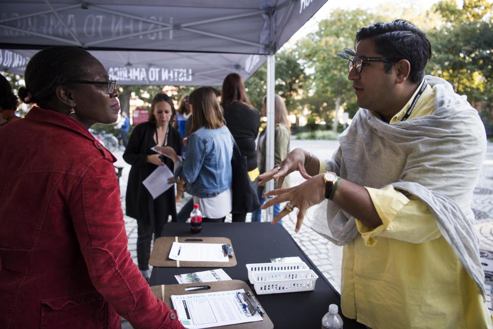 HuffPost reporter Akbar Shahid Ahmed talks to a woman about signing up to be interviewed.