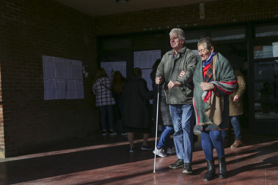 Voters leave a polling station during primary elections in Buenos Aires, Argentina, Sunday, Aug. 13, 2023. (AP Photo/Daniel Jayo)