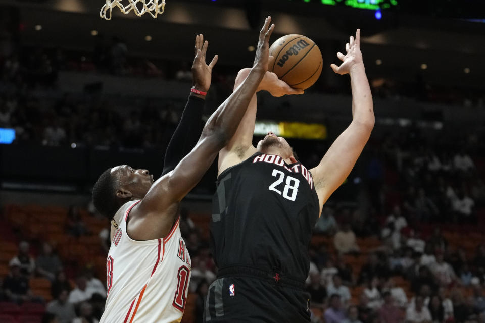 Houston Rockets center Alperen Sengun (28) is fouled by Miami Heat center Bam Adebayo during the first half of an NBA basketball game Friday, Feb. 10, 2023, in Miami. (AP Photo/Lynne Sladky)