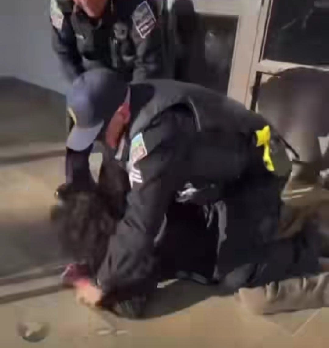 In this screenshot from a Las Cruces For Palestine Instagram livestream, a protester is wrestled to the ground by law enforcement at Hadley Hall on the New Mexico State University campus on Thursday.