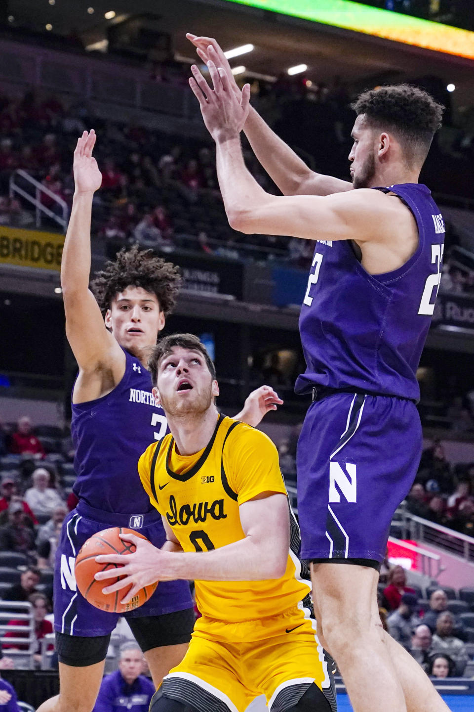 Iowa forward Filip Rebraca (0) shoots under Northwestern forward Pete Nance (22) in the first half of an NCAA college basketball game at the Big Ten Conference tournament in Indianapolis, Thursday, March 10, 2022. (AP Photo/Michael Conroy)