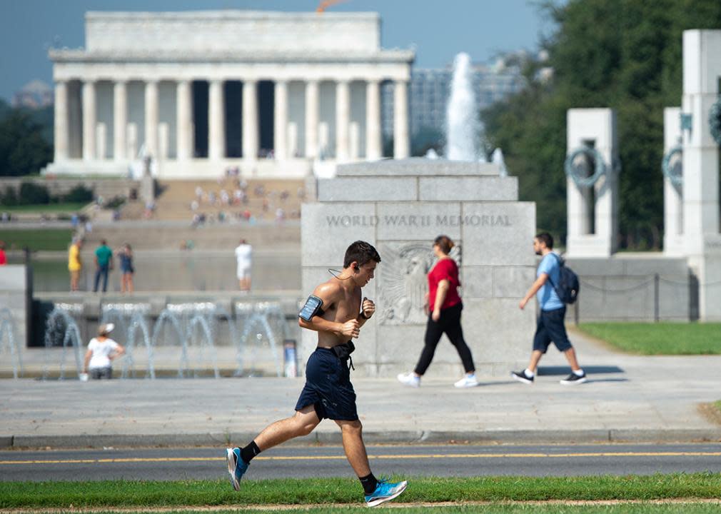 A man jogs near the National World War II Memorial and Lincoln Memorial on the National Mall in Washington, DC.