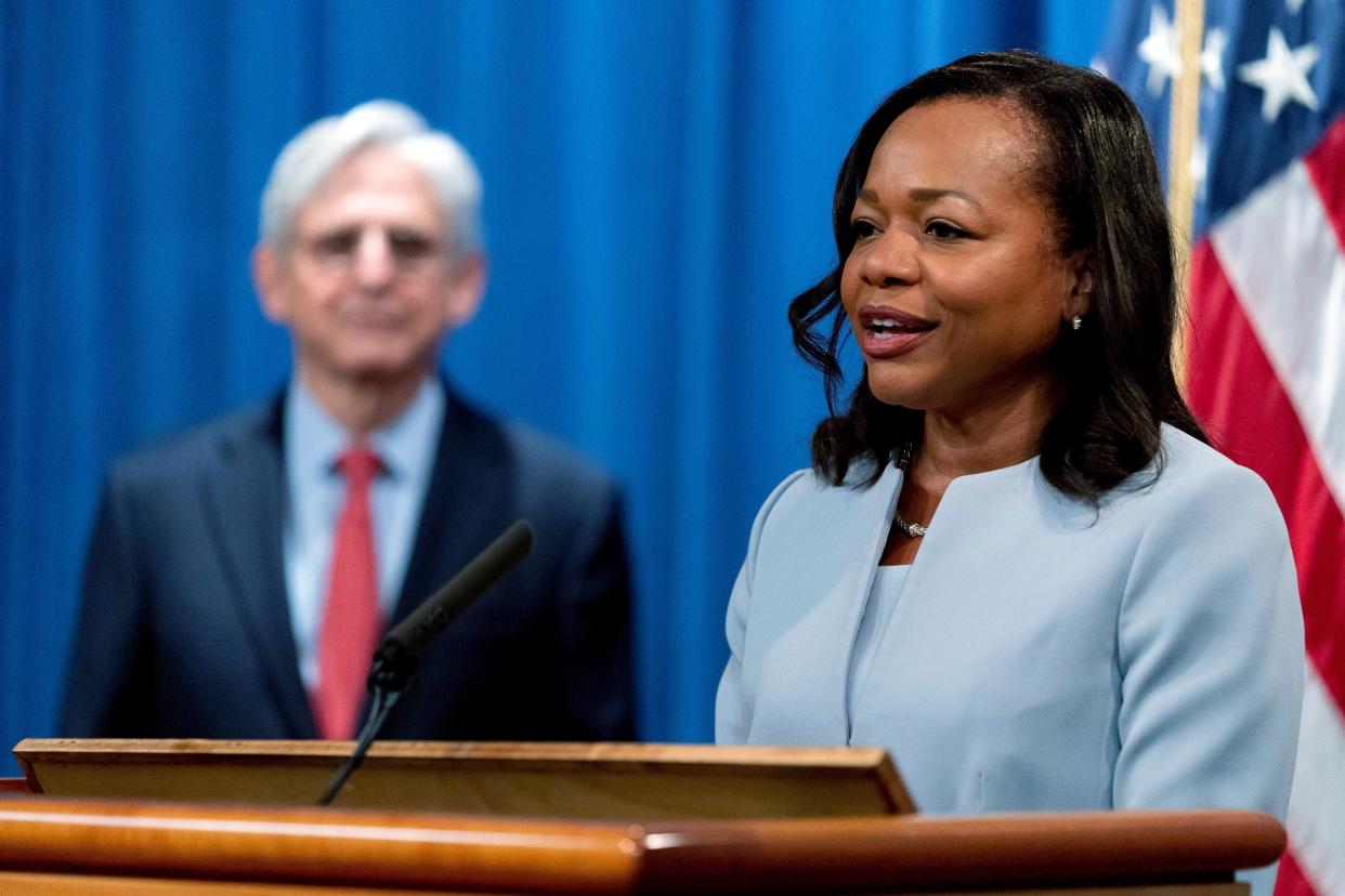 Assistant Attorney General for Civil Rights Kristen Clarke, right, accompanied by Attorney General Merrick Garland, left, speaks at a news conference at the Department of Justice in Washington on Aug. 5, 2021. The DOJ on Thursday announced an agreement with Evolve Bank & Trust on Thursday to resolve allegations of lending discrimination.