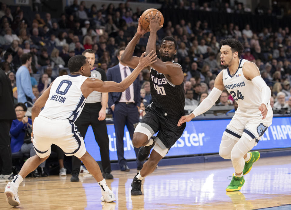 Sacramento Kings forward Harrison Barnes (40) drives to the basket while defended by Memphis Grizzlies guards De'Anthony Melton (0) and Dillon Brooks (24) during the first half of an NBA basketball game Friday, Feb. 28, 2020, in Memphis, Tenn. (AP Photo/Nikki Boertman)