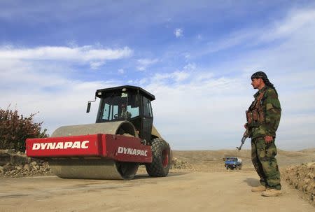 An Afghan security personnel keeps watch at a road construction site, which is being built by a Chinese company, in Khogyani district of Nangarhar province November 19, 2015. REUTERS/Parwiz