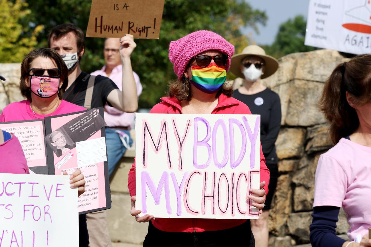 People listen to speakers during the Warren County March for Reproductive Freedom in Mason Saturday, October 2, 2021, outside of the Mason. Municipal Center.