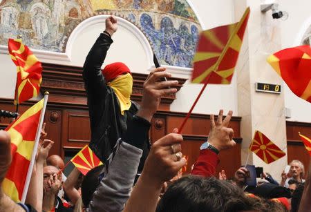 Protesters entered Macedonia's parliament after the governing Social Democrats and ethnic Albanian parties voted to elect an Albanian as parliament speaker in Skopje. Macedonia April 27, 2017. REUTERS/Ognen Teofilovski