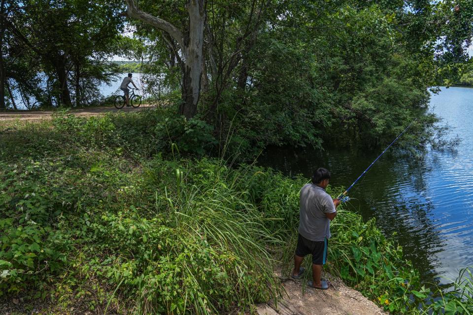 Junior Jimenez fishes near the Butler trail on Saturday. Trailgoers have said they want more spaces for fishing.