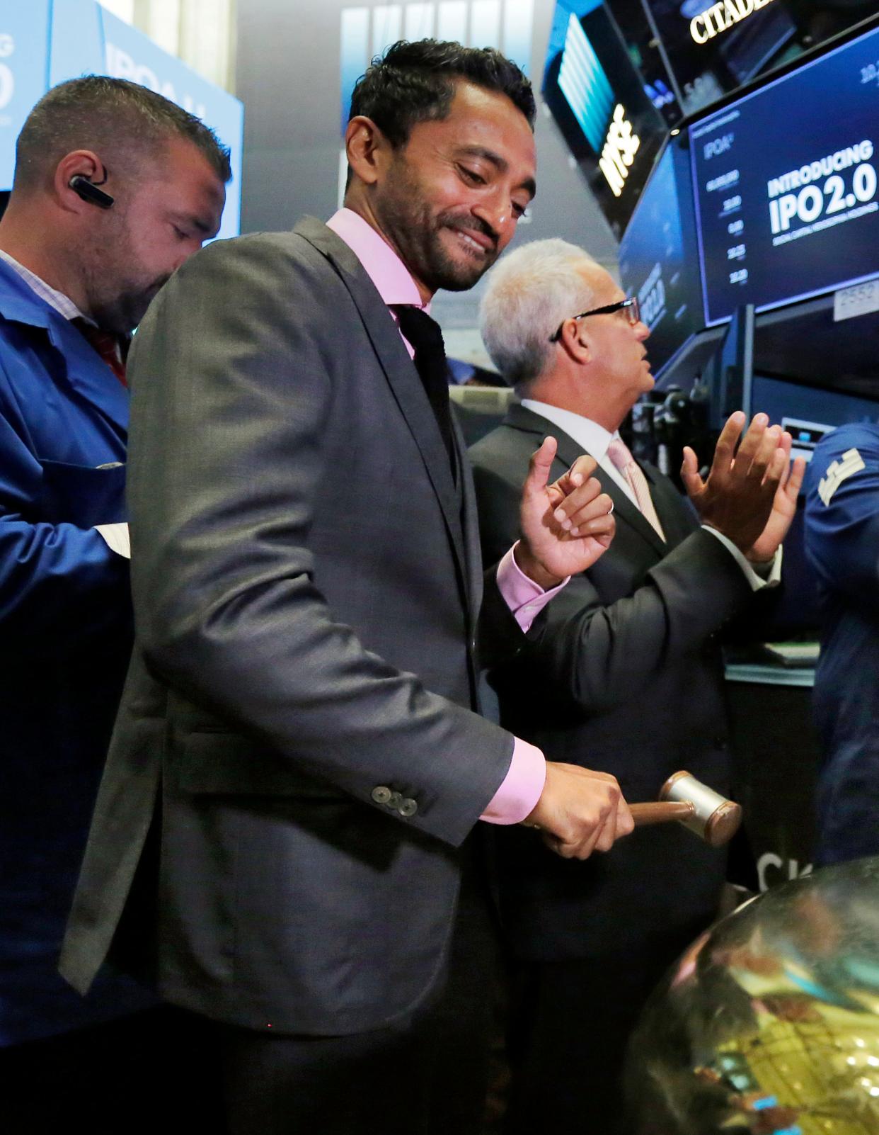 Chamath Palihapitiya, center, rings a ceremonial bell on the floor of the New York Stock Exchange, Thursday, Sept. 14, 2017. Palihapitiya, a Golden State Warriors NBA basketball team minority owner who said "nobody cares" about the Uyghurs in China, is under fire and the team is distancing itself from him. On the latest edition of his All-In Podcast, the billionaire dismissed the situation in China, which is accused by the U.S. of genocide and crimes against humanity with treatment of the Uyghurs Muslim minority population in its Xinjiang region of Northwest China.