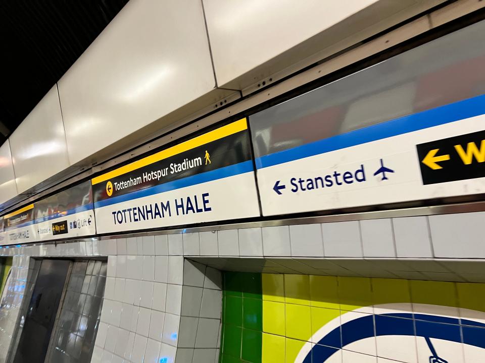 A sign reads "Tottenham Hale" and has directions to Stansted Airport at the London Underground station.