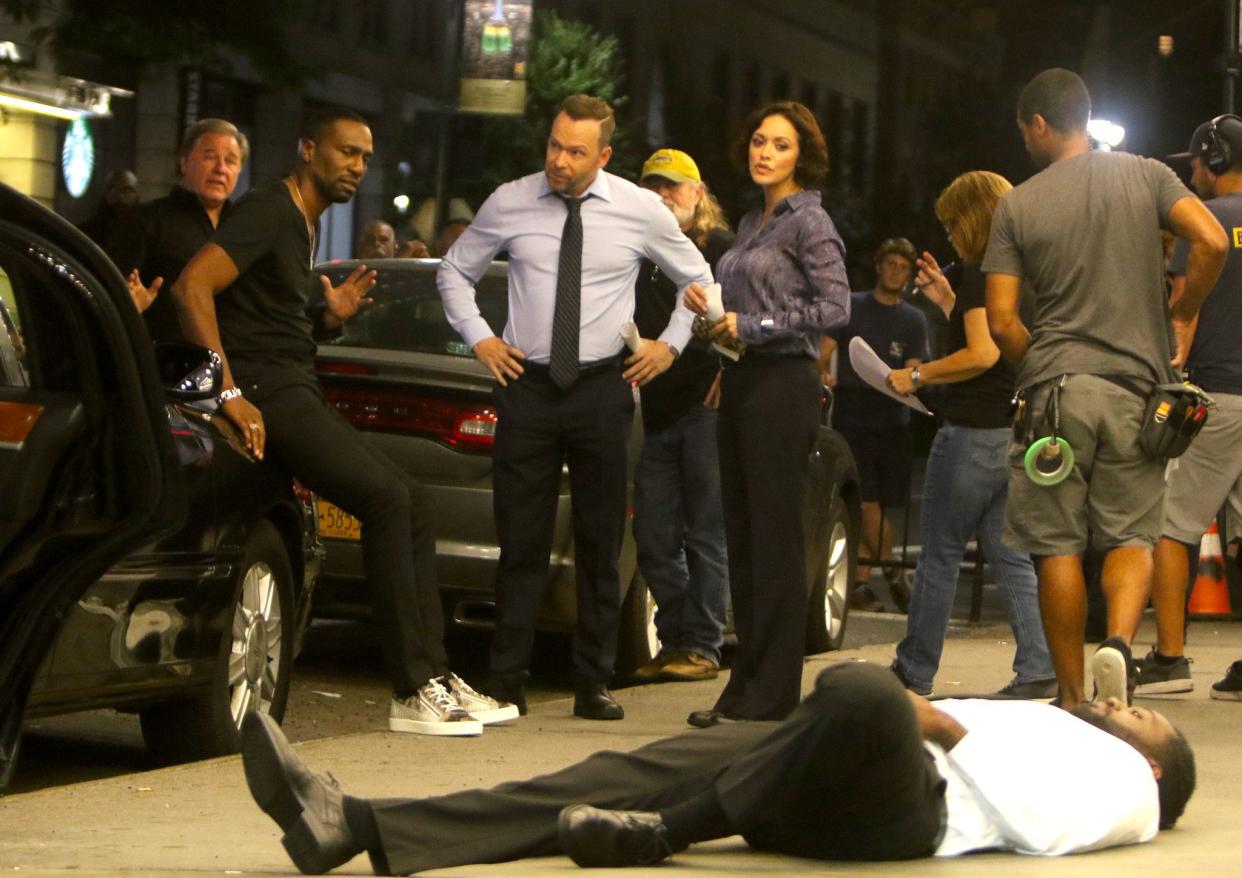 Donnie Wahlberg (c), Marisa Ramirez and Leon Robinson are seen in Midtown, Manhattan filming a crime scene for "Blue Bloods" on Sept. 4, 2019.