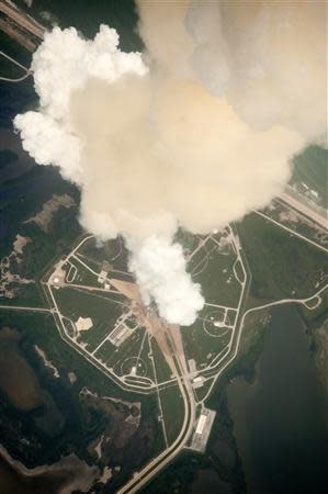 The exhaust plume from Space Shuttle Atlantis is seen through the window of a Shuttle Training Aircraft as it launches from pad 39A at the Kennedy Space Center in this NASA handout photo from July 8, 2011. REUTERS/NASA/Handout