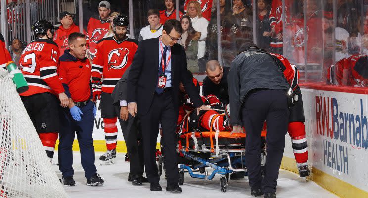 John Moore is stretchered off the ice following a hit from Tom Wilson. (Bruce Bennett/Getty Images)