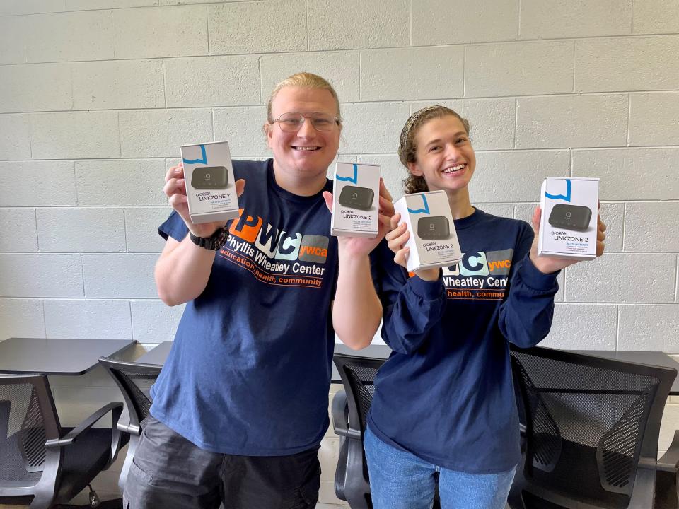 Seth Naekel and Shelby Kleiner hold hotspots donated by UScellular as part of the After School Access Project.