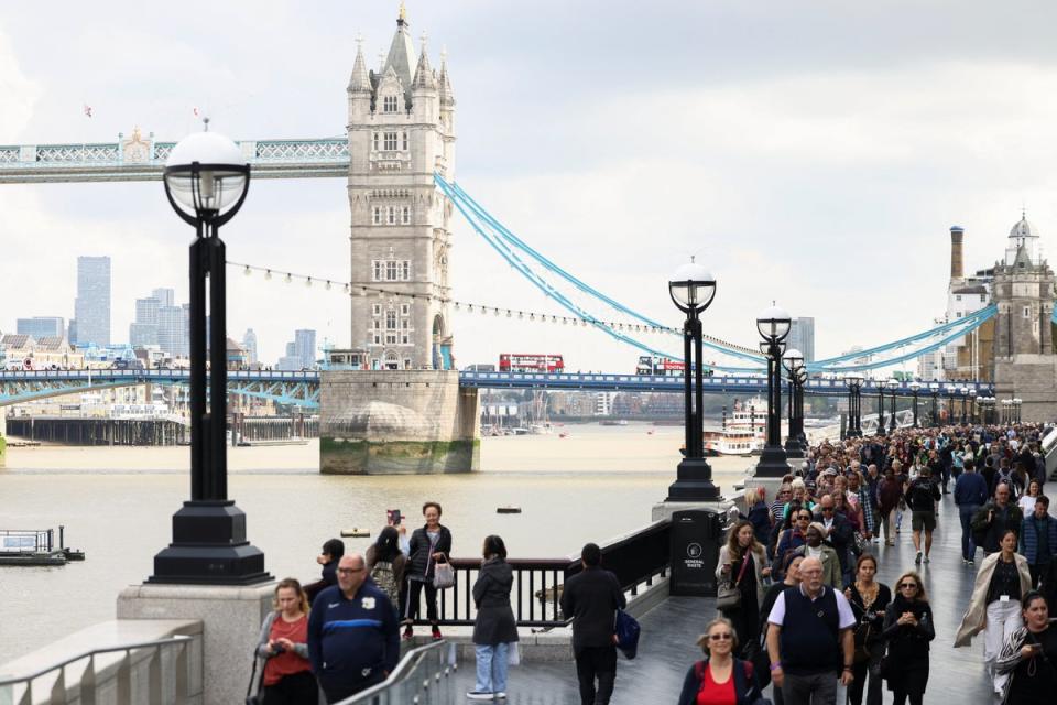 People queue near Tower Bridge to pay their respects (REUTERS)