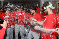 Members of the Philadelphia Phillies including Bryce Harper, right, and Kyle Schwarber, second from left, celebrate in the clubhouse after defeating the St. Louis Cardinals to win a National League wild-card baseball playoff series, Saturday, Oct. 8, 2022, in St. Louis. (AP Photo/Scott Kane)
