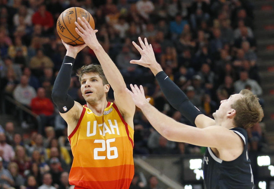 Detroit Pistons guard Luke Kennard, right, defends against Utah Jazz guard Kyle Korver (26) during the second half of an NBA basketball game Monday,Jan. 14 , 2019, in Salt Lake City. (AP Photo/Rick Bowmer)