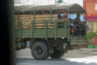 FILE - In this May 23, 2021, file photo, military troops and police go on patrol at Kayah state, eastern Myanmar. At least one-quarter of the people in Myanmar's smallest state have been forced to flee their homes because of combat with the military junta that seized power in February, raising fears of a possible humanitarian tragedy including thousands of civilian deaths, a U.N. expert said Wednesday, June 9.(AP Photo/File)