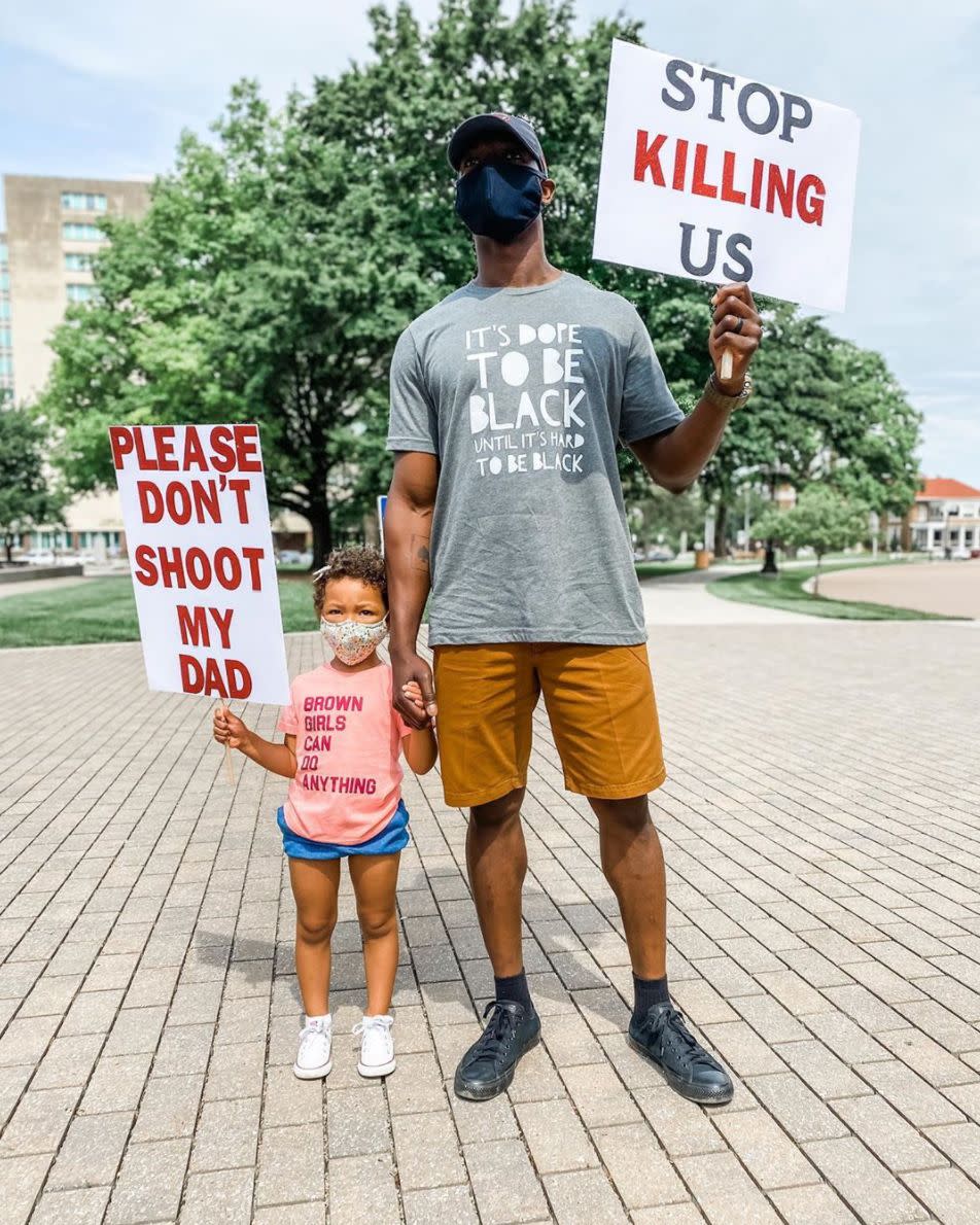 <i>Breezy Rose of Kansas posted this photo of her husband holding a sign that says "Stop killing us" and her daughter holding a sign that says "Please don't shoot my dad" on Instagram. In the caption, Breezy wrote: "When I tell you I cried after snapping this picture at a rally for George Floyd today, I sobbed. This is our reality. This is reality for every black person in our country. Today I wept for George Floyd, for Breonna Taylor, for Ahmaud Arbery, for Eric Garner, for Sandra Bland, for Tamir Rice and for so many others. Today I wept for my husband having to teach this to our daughter. And today I wept for our daughter, who has to grow up with this fear. Today, we wept. But tomorrow, we fight." </i>