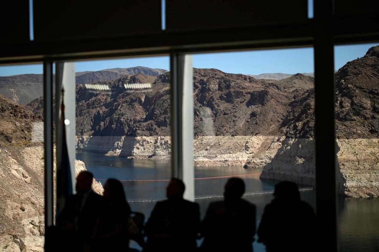 Officials listen during a news conference on Lake Mead at the Hoover Dam on Tuesday, April 11, 2023, near Boulder City, Nev.