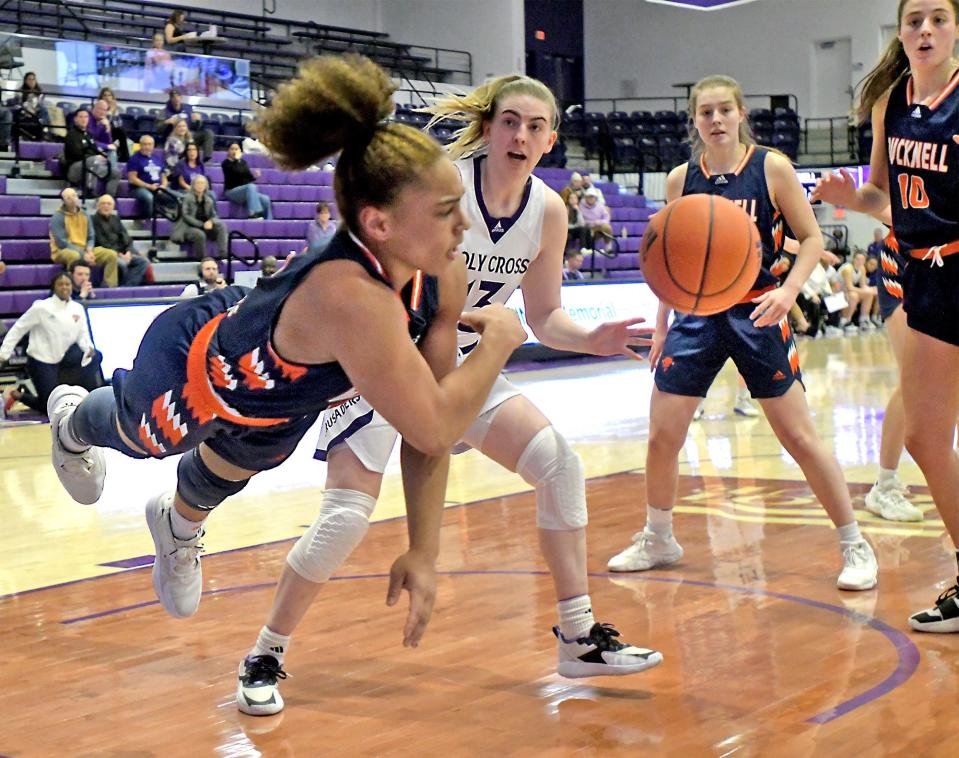 Bucknell's Blake Matthews makes a diving effort to save the ball from going out of bounds, as Holy Cross' Bronagh Power-Cassidy defends.