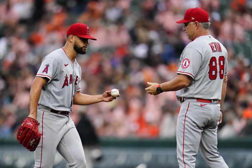 Los Angeles Angels interim manager Phil Nevin (88) takes the ball from starting pitcher Patrick Sandoval while going to the bullpen for a reliever against the Baltimore Orioles during the seventh inning of a baseball game, Saturday, July 9, 2022, in Baltimore. The Orioles won 1-0. (AP Photo/Julio Cortez)