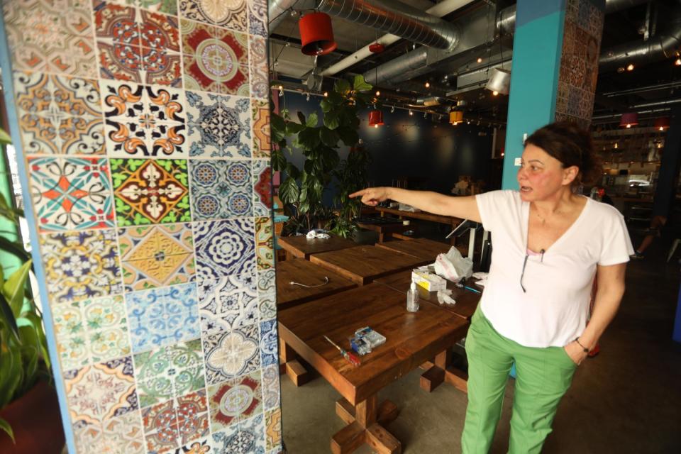 Nicole Chammaa, owner of Sunnin Lebanese Cuisine, stands inside the vandalized restaurant in Santa Monica
