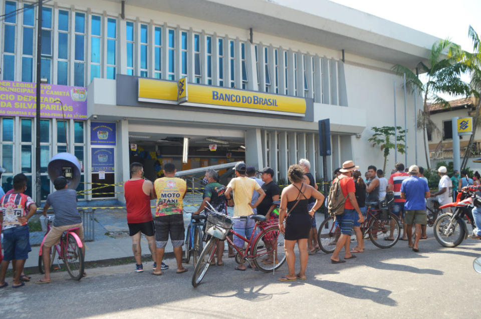 People look into the bank which robbers struck just after midnight, in Cameta, Para State, in northern Brazil, on December 2, 2020. Source: AFP via Getty