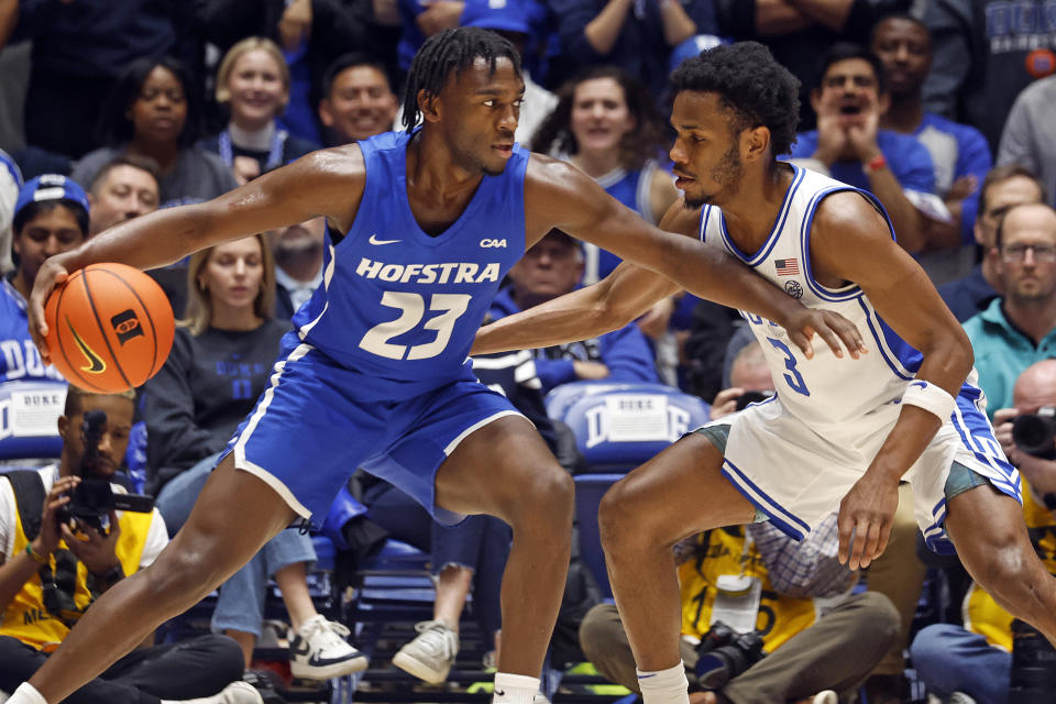 Hofstra's Tyler Thomas (23) protects the ball from Duke's Jeremy Roach (3) during the first half of an NCAA college basketball game in Durham, N.C., Tuesday, Dec. 12, 2023. (AP Photo/Karl B DeBlaker)