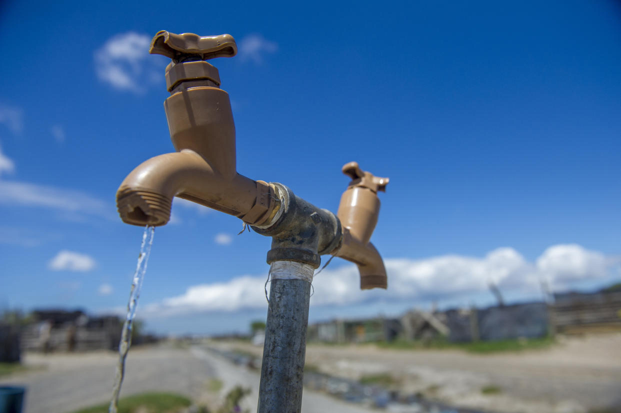 A communal tap runs for people in an informal settlement near Cape Town, South Africa, in January 2018. While the city urged residents to restrict water usage, many living in poor areas already had limited access to water. (Photo: ASSOCIATED PRESS)