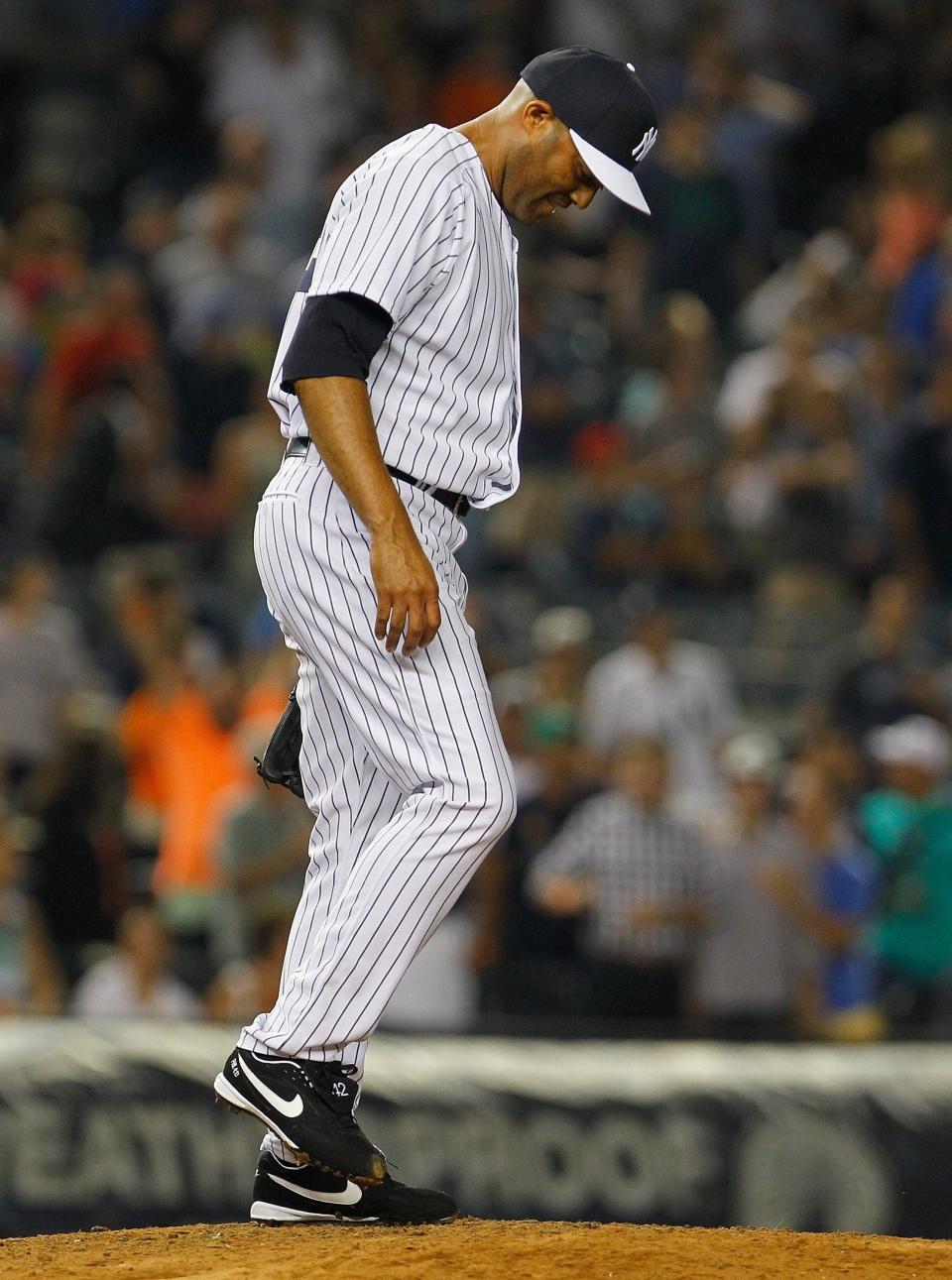 Mariano Rivera of the New York Yankees reacts after giving up a game-tying two run home run to Miguel Cabrera #24 of the Detroit Tigers in the ninth inning at Yankee Stadium on August 9, 2013.